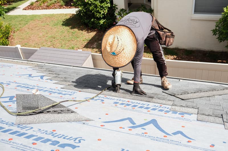 Certified Best Roofing crew member installing architectural shingles