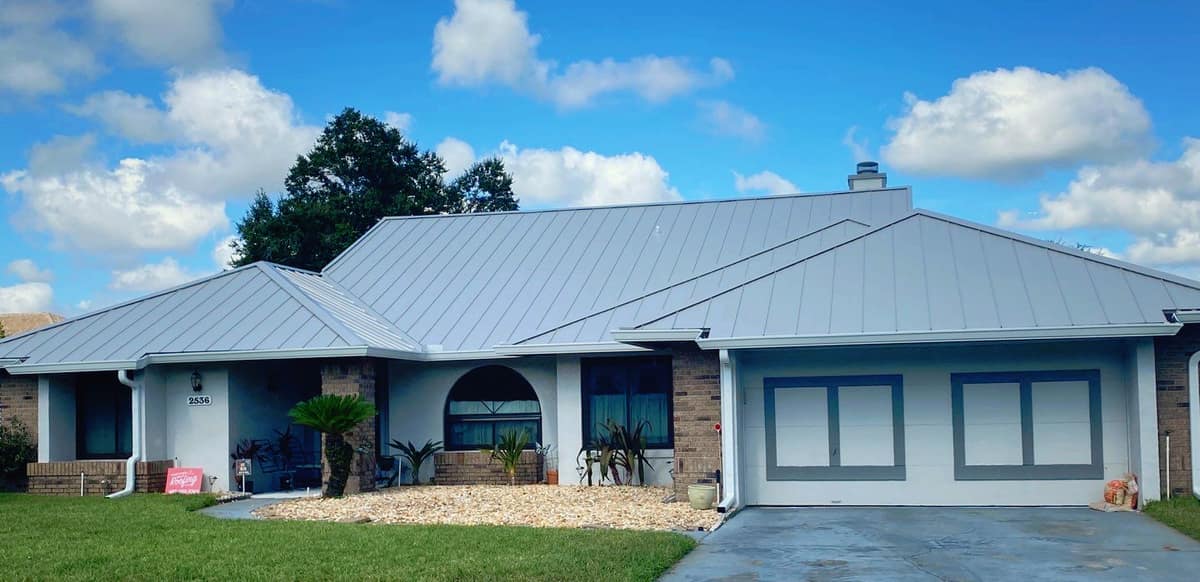 Sleek standing-seam metal roof gleaming in sunlight on a modern Florida home