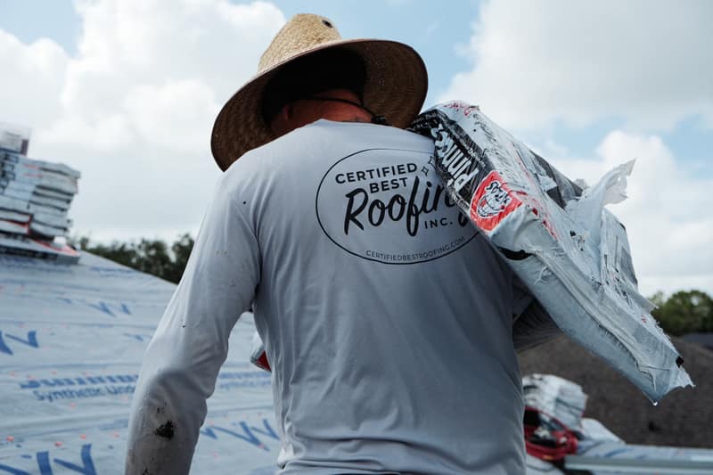 Roofer tracing and repairing a roof leak on a Florida home