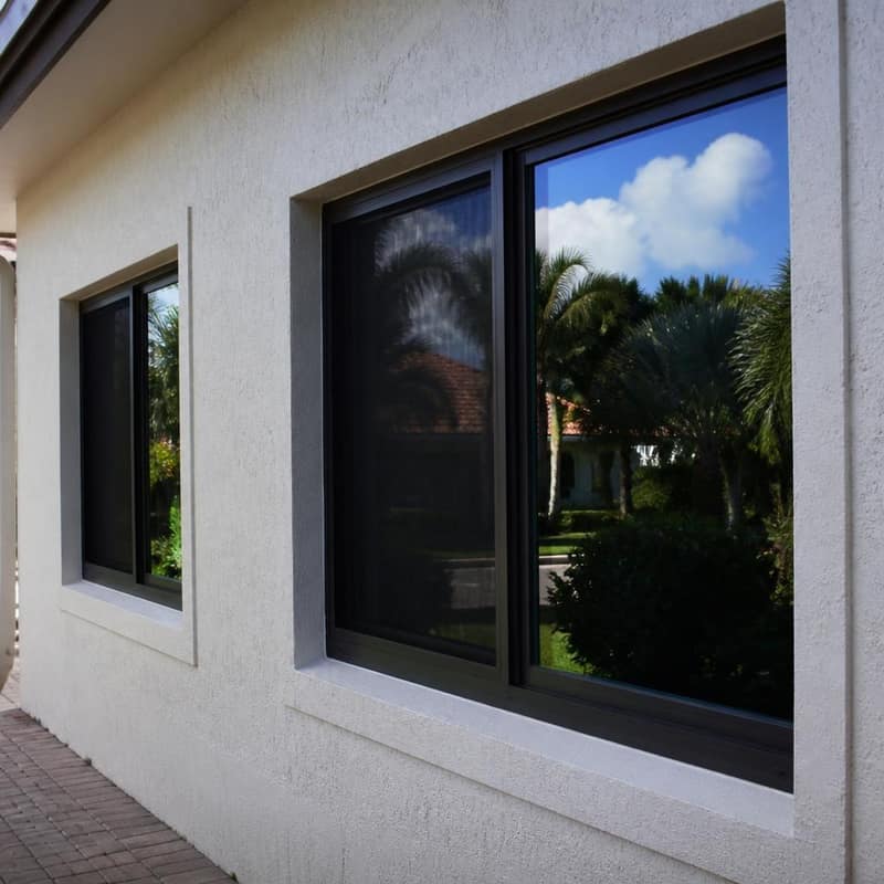 Energy-efficient impact windows reflecting sunlight on a Florida home